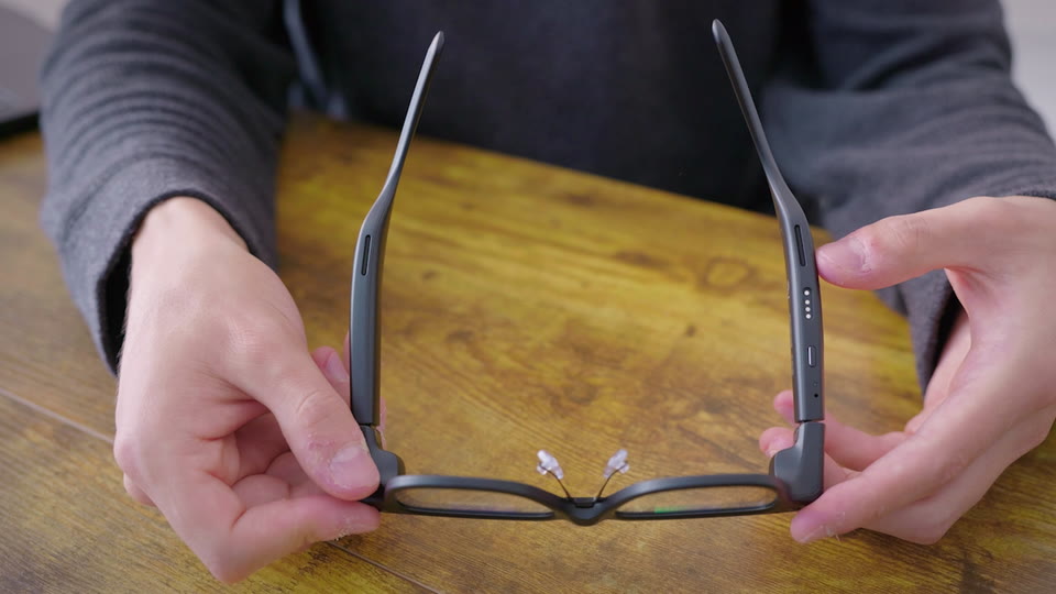 Connect the charger to the charging pins. The red light means the glasses are charging.